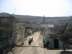 The entrance to a shantytown "Asentamiento Humano 14 de Diciembre"